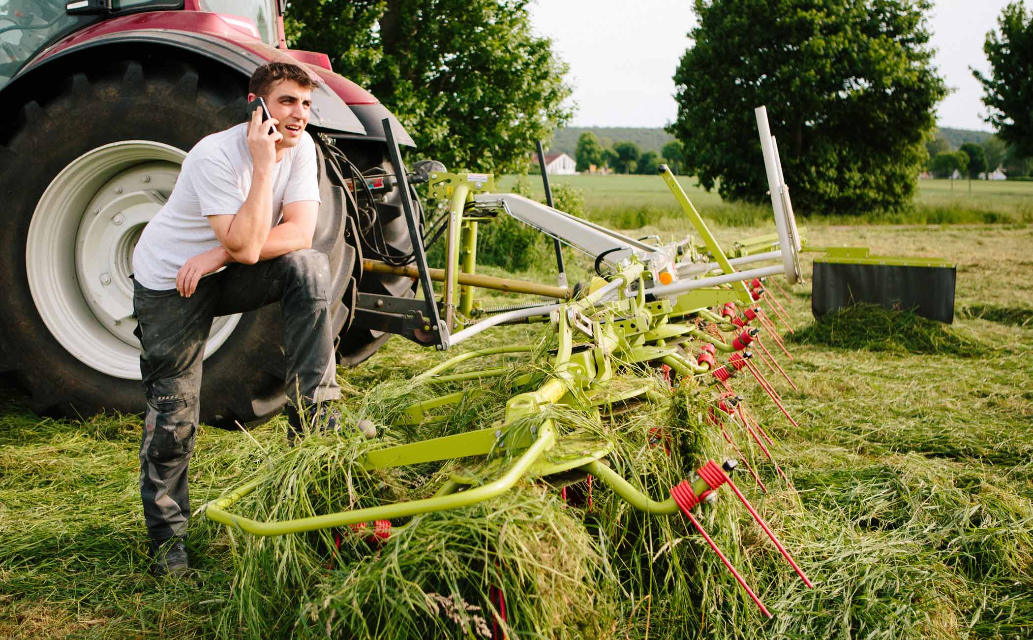 man on the phone working tractor