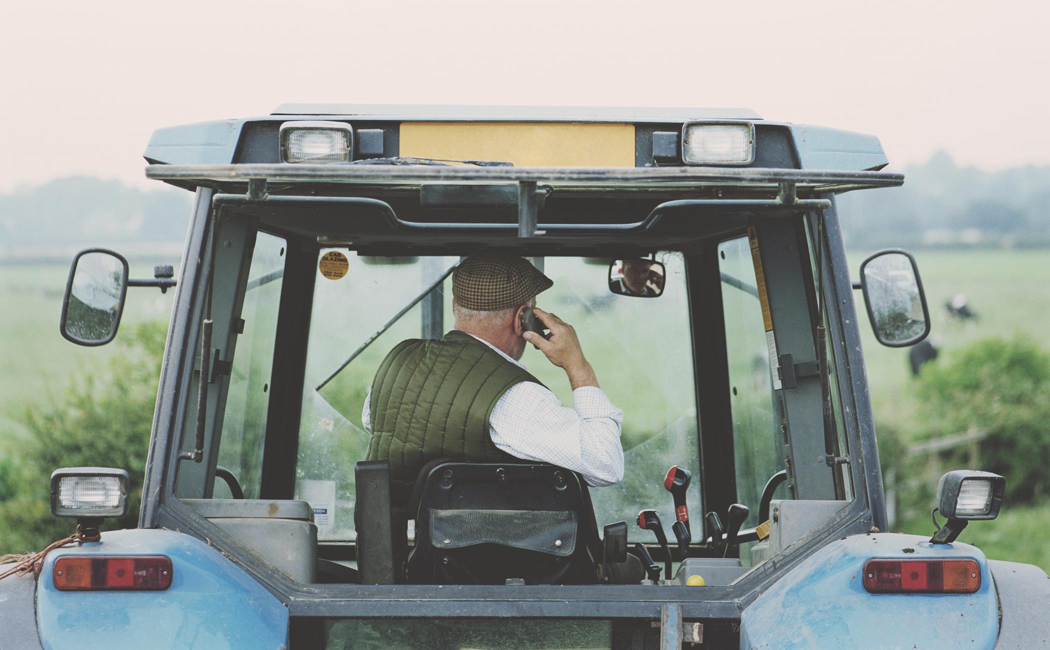 man on the phone in a tractor